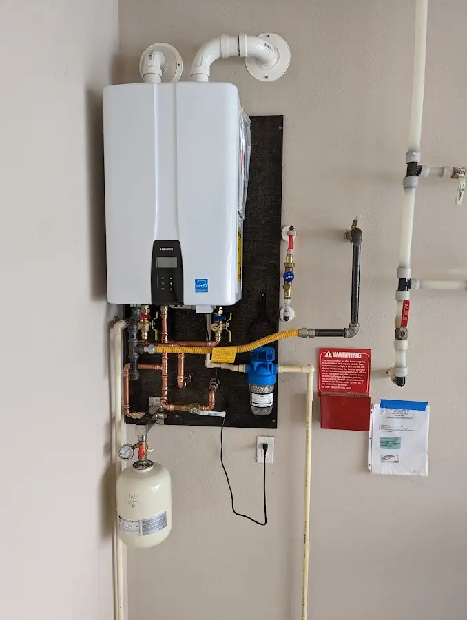 Professional plumber installing copper piping in a American Fork home